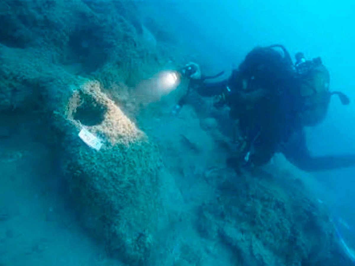 A diver examines a ceramic vessel on the seabed near Kekova, Turkey.