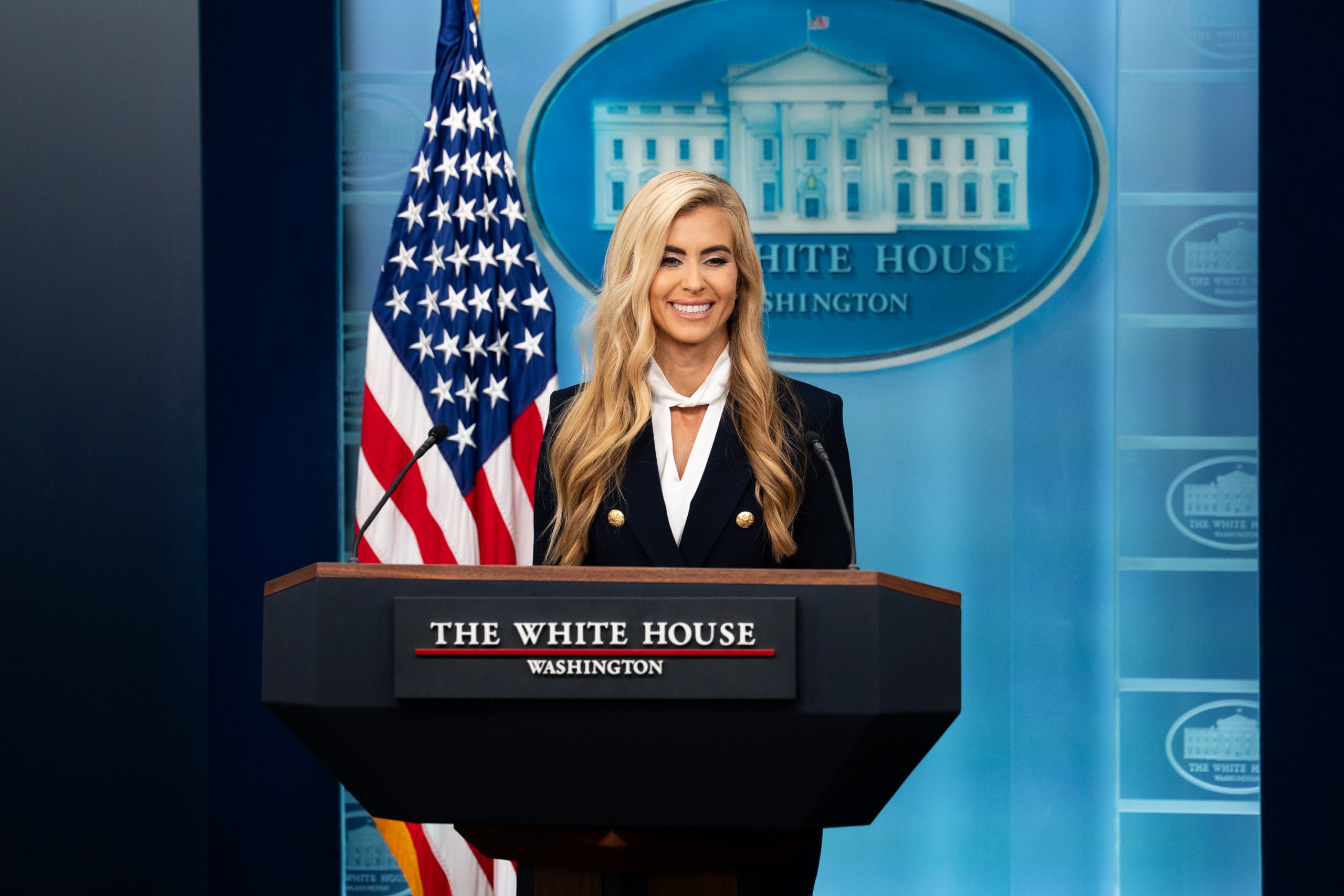 Katie Zacharia at the White House briefing podium on 13 October 2026.