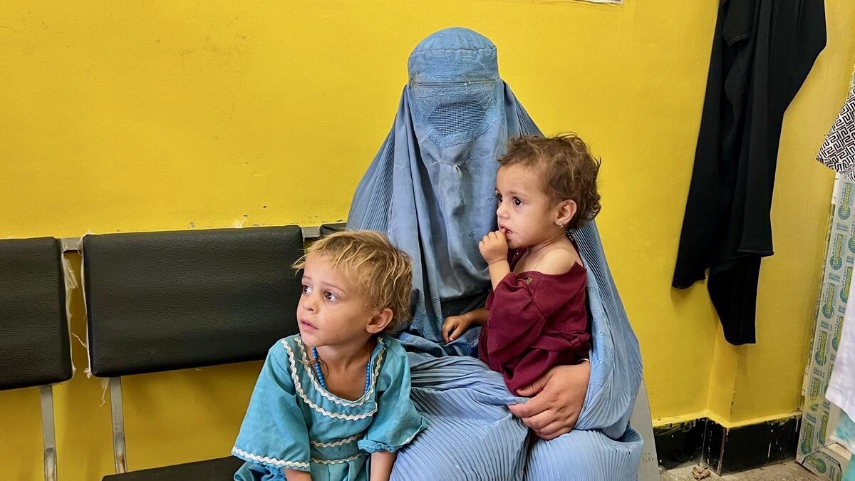 Sediqa sits with her two young daughters at a health centre in southern Afghanistan.